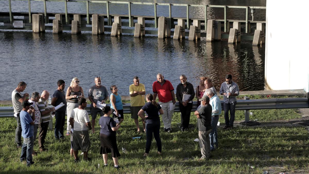 Attorney Nejla Calvo (center) of Legal Services of Greater Miami, Inc. talks to residents of the Paradise Mobile Home Park in Miami during a homeowners association meeting held under the 27th Avenue bridge that crosses the Miami River on Sept. 23, 2019.