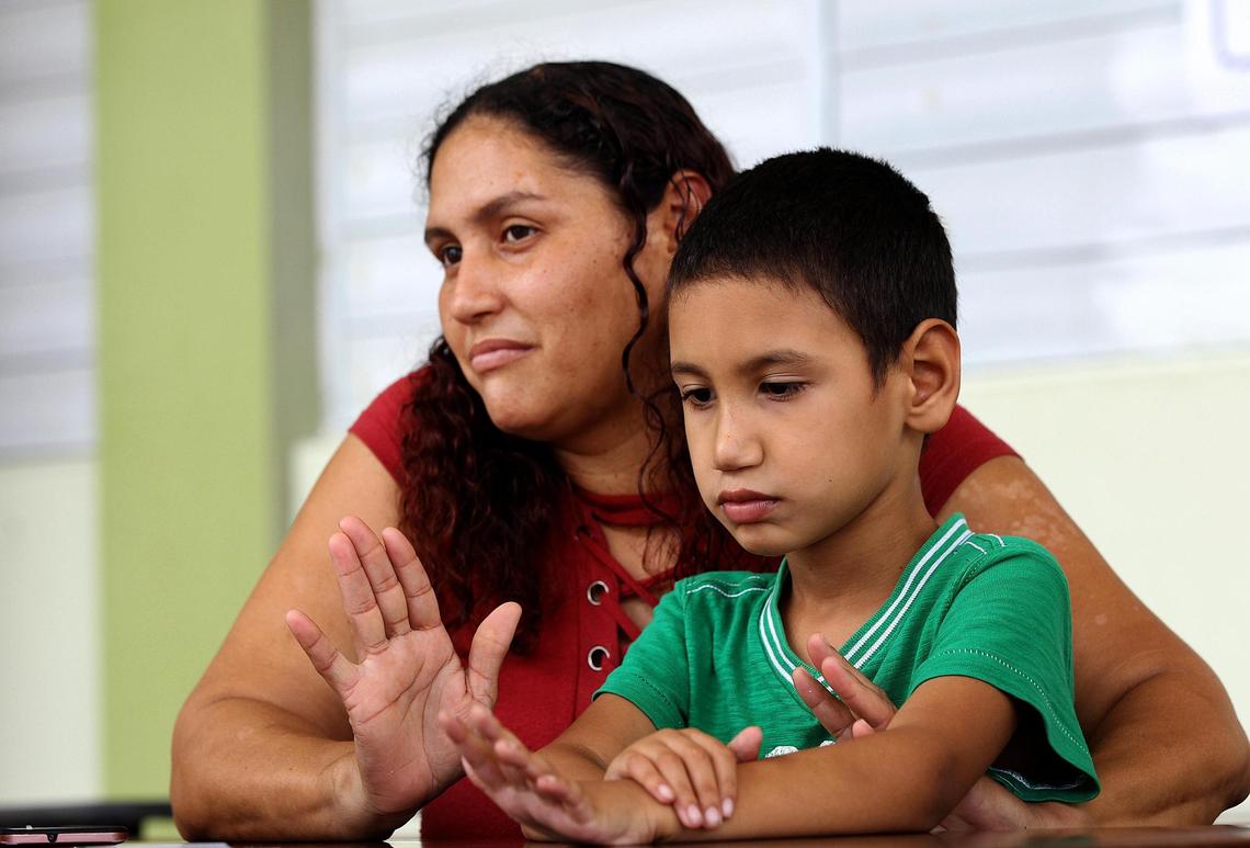 Brenda López, with her son Angel Miguel Torres, who has special needs. Finding a new school and teacher has been difficult after Hurricane Maria and a wave of school closures.