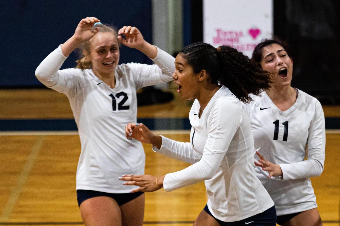 Gulliver Prep volleyball middle blocker Jackie Taylor (1) (middle) reacts with Hailey Brenner (12) (left) and Maya Pace (11) (right) during a game against Saint Andrew’s at Gulliver Prep School in Pinecrest, Florida on Monday, October 3, 2022.