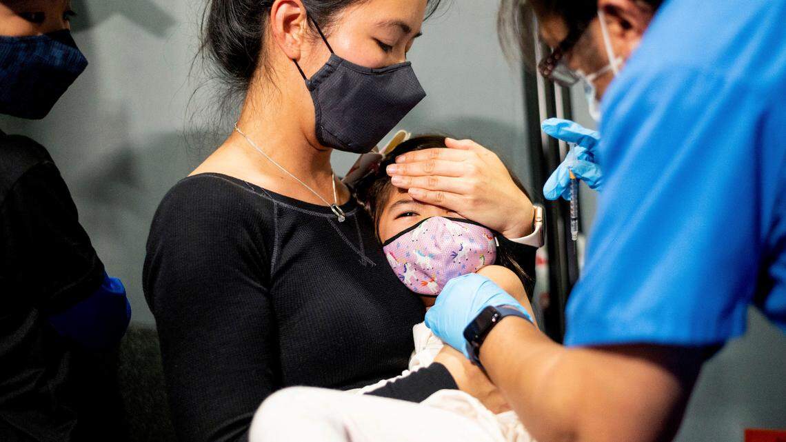 Christina Yep holds daughter Ariel Yep, 5, as she receives a Pfizer-BioNTech COVID-19 vaccine in San Jose, Calif., on Wednesday, Nov. 3, 2021.