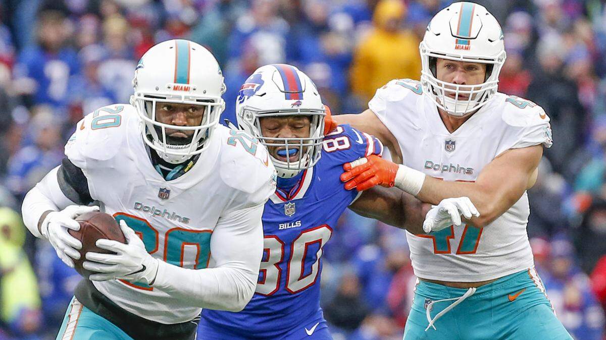 Miami Dolphins free safety Reshad Jones (20) intercepts the pass intended for Buffalo Bills tight end Jason Croom (80) in the second quarter as Jones runs it in for a pick six in the second quarter as the Buffalo Bills host the Miami Dolphins at New Era Field, Orchard Park, NY on Sunday, December 30, 2018.