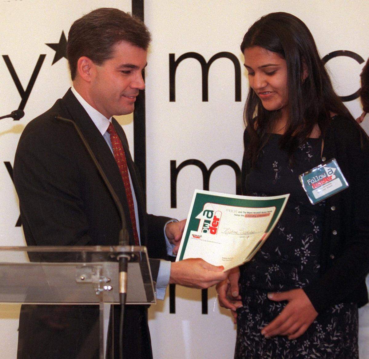 Nishma Sachedina receives her award from Miami-Dade County Mayor Alex Penelas at the “Follow the Leader” breakfast banquet being held at Macy’s in Aventura Wednesday November 3, 1999.