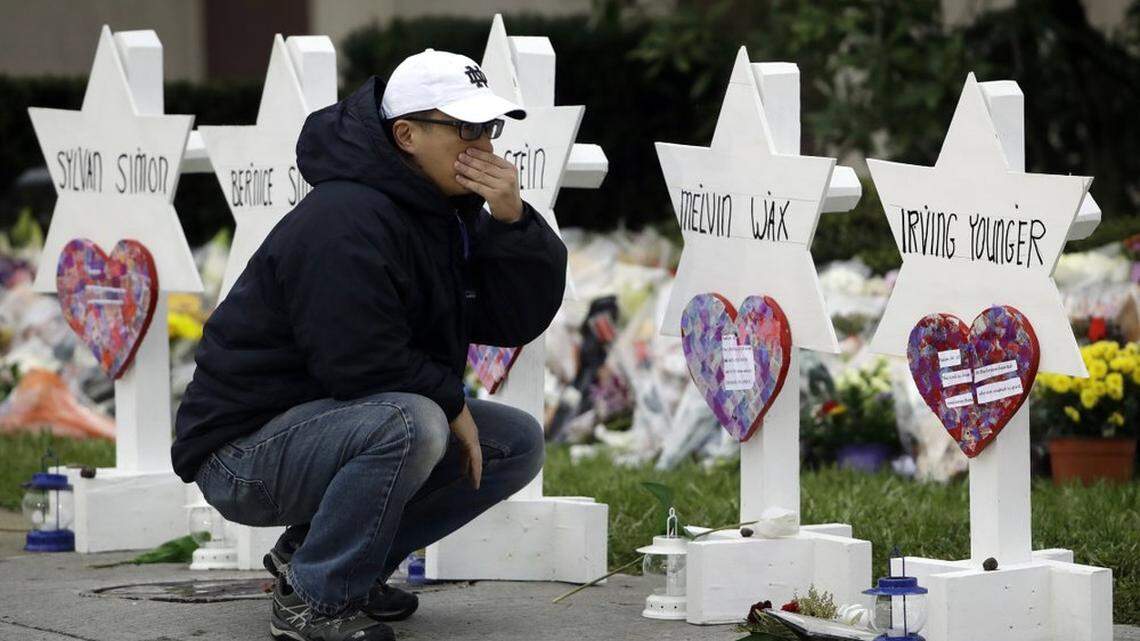 A man pauses in front of Stars of David with the names of those killed in a deadly shooting in 2018 at the Tree of Life Synagogue, in Pittsburgh.