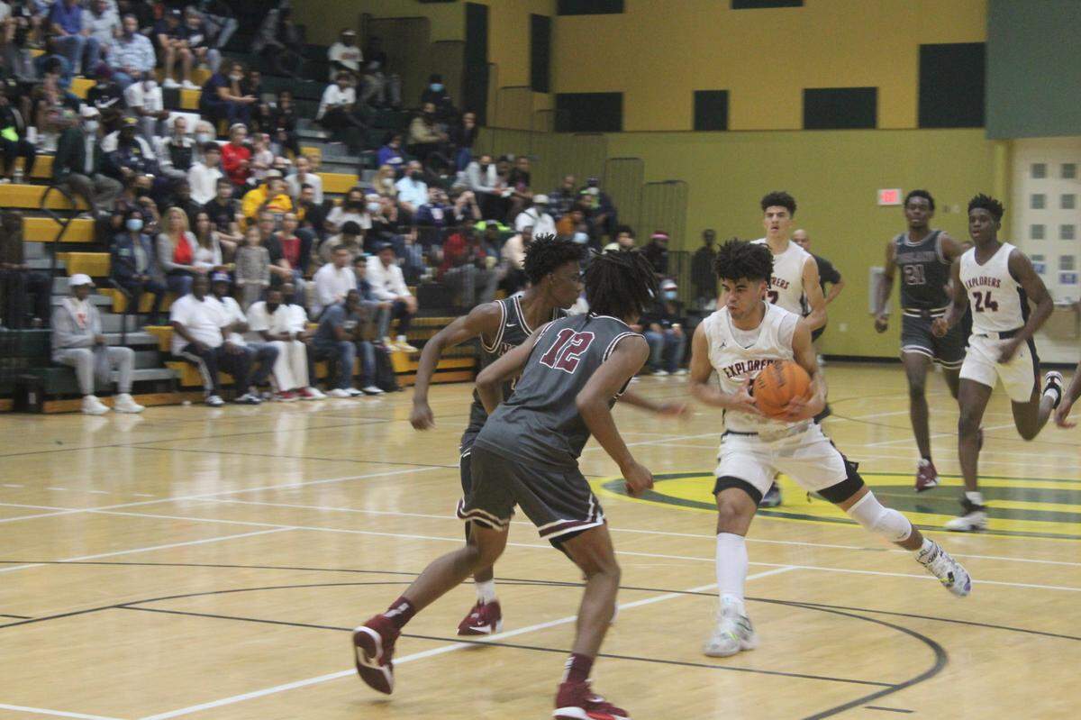 Columbus’ Cayden Boozer drives to the basket as Norland’s Carl Parrish defends during Thursday night’s GMAC boys’ basketball championship game at Miami Jackson High.