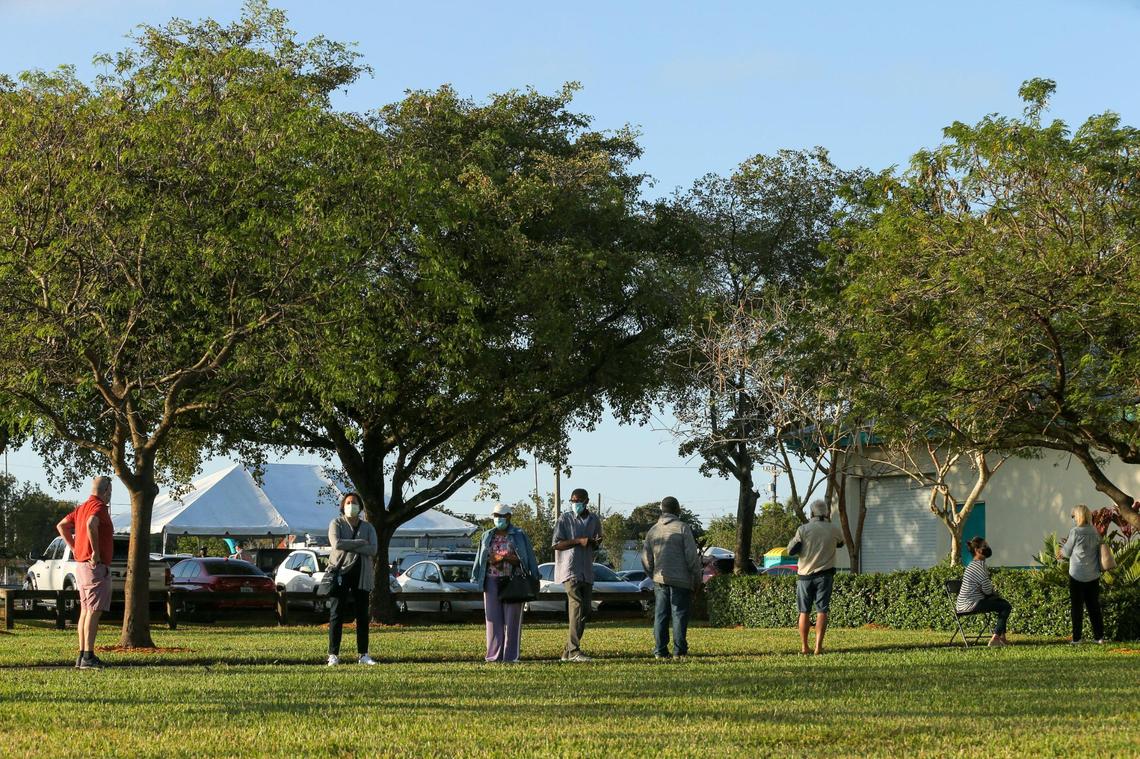 Vaccination seekers wait in line outside at the first walk-up mobile testing site open to Florida resident that won’t require appointments at Miami Carol City Park in Miami Gardens in Miami Gardens, Florida on Saturday, February 20, 2021.