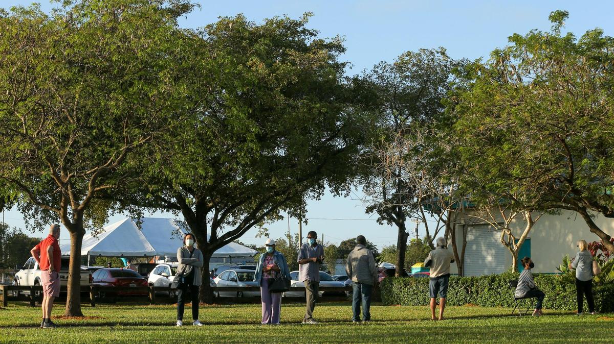 Vaccination seekers wait in line outside at the first walk-up mobile testing site open to Florida residents that won’t require appointments at Miami Carol City Park in Miami Gardens, Florida, on Saturday, Feb. 20, 2021.