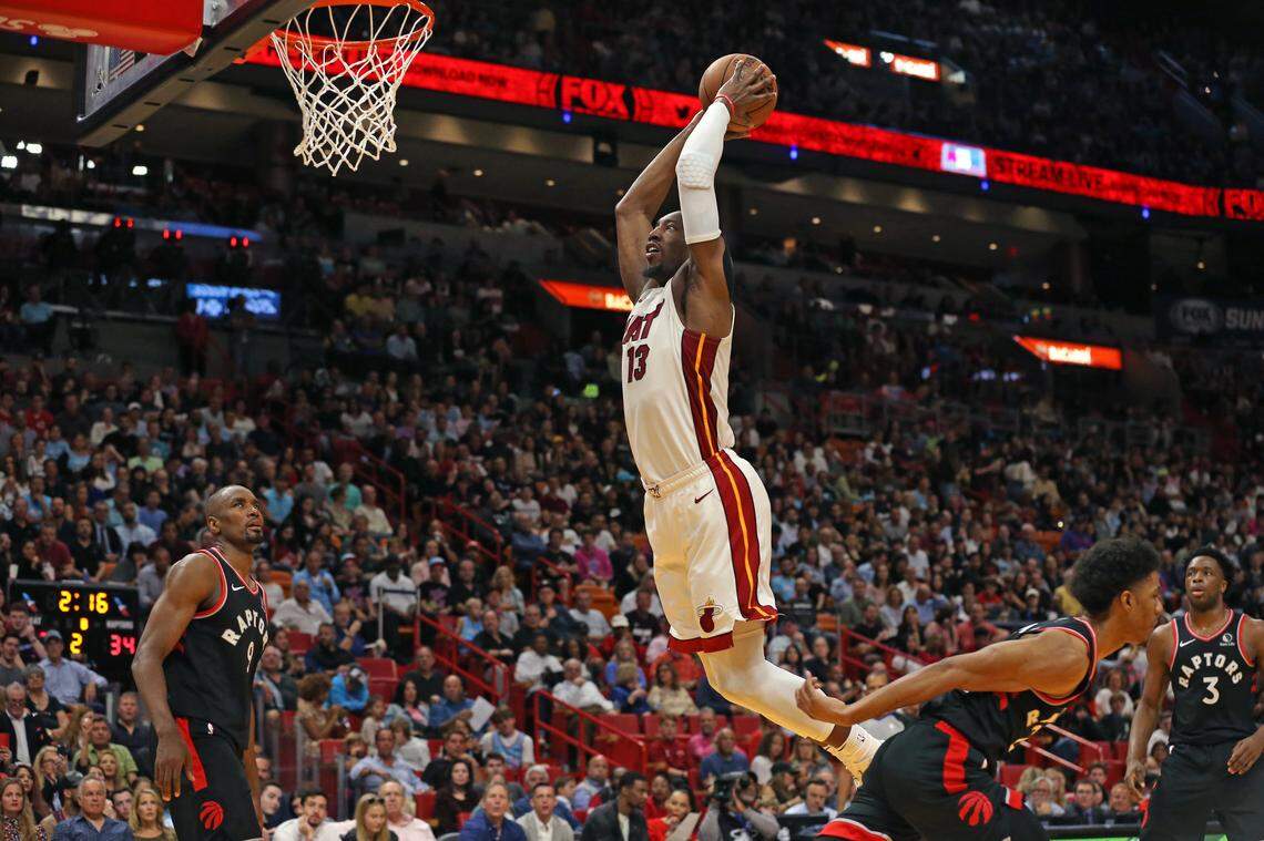 Miami Heat center Bam Adebayo (13) dunks against Toronto Raptors forward Serge Ibaka (9) in the second quarter of an NBA basketball regular season game at the AmericanAirlines Arena on Thursday, January 2, 2020 in Miami.