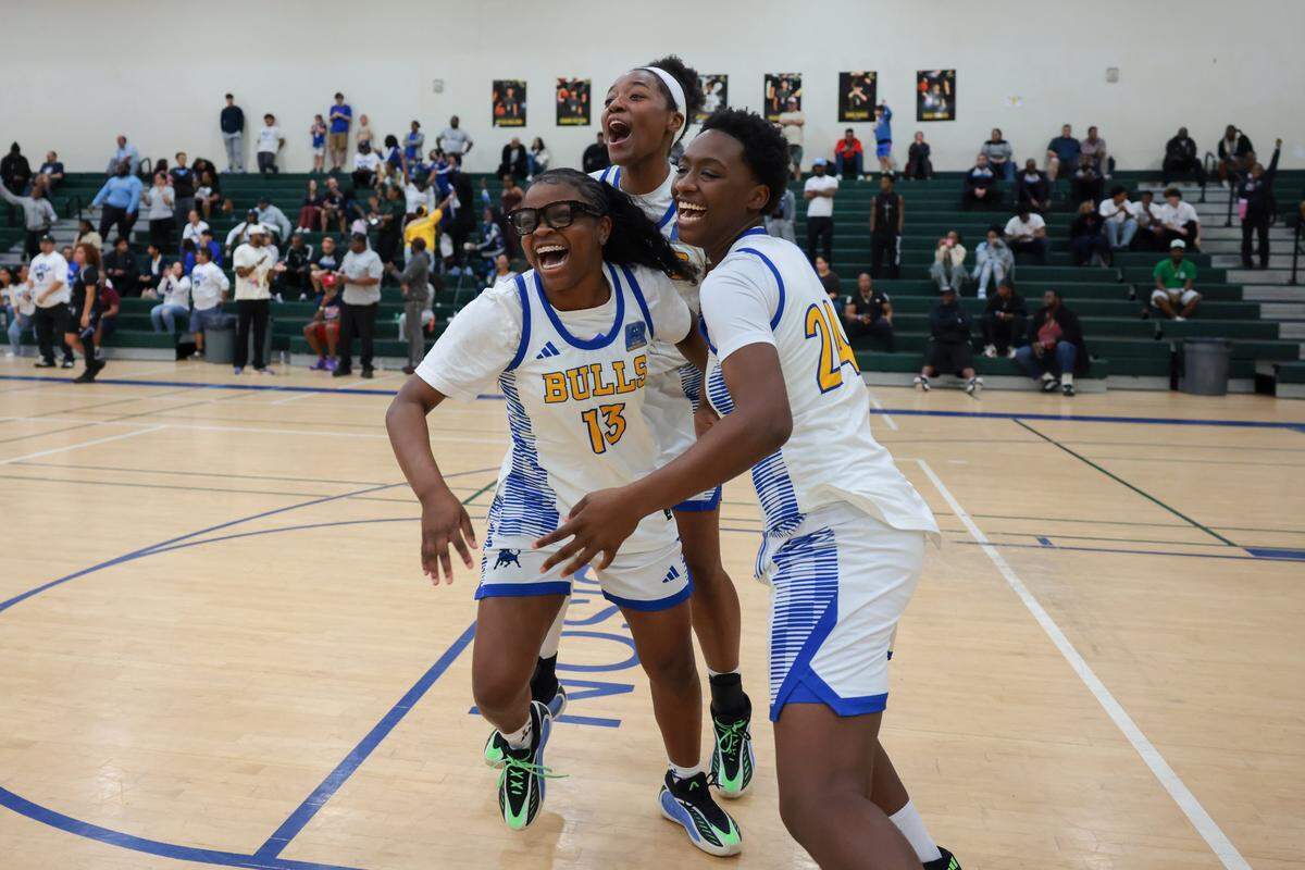 Northwestern Bulls Zahara Leaks (13), Myah Newton (11), and Tayana Dixon (24) celebrate after defeating the South Dade Buccaneers during overtime in the Greater Miami Athletic Conference girls basketball finals game at Ronald W. Reagan Doral Senior High School on Saturday, Jan. 24, 2026, in Doral, Fla.