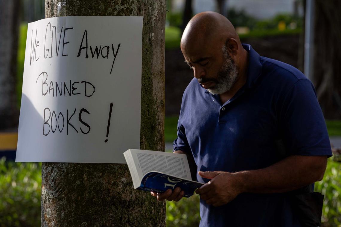 Ph.D. in International Relations Rob Piper, 53, reads a copy of ‘The 1619 Project’ by Nikole Hannah-Jones while waiting for speaker Marvin Dunn to speak to attendees about the Rosewood Massacre during a “Black History Learning Tree” event at FIU on Tuesday, April 1, 2025, in Miami, Fla.