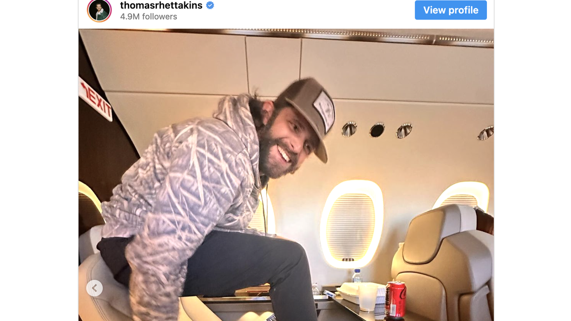 Thomas Rhett sits on a plane.