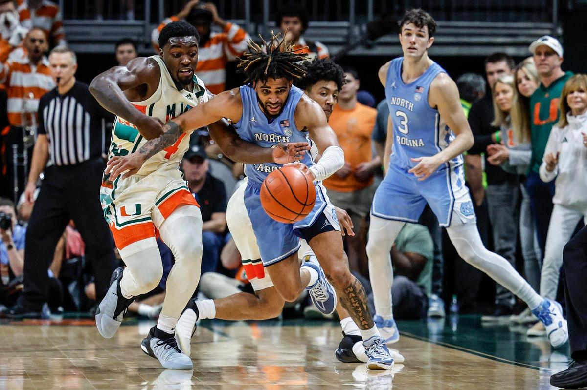 Miami Hurricanes guard Bensley Joseph (4) and North Carolina Tar Heels guard RJ Davis (4) battle for control of the ball during the second half at the Watsco Center in Coral Gables, FL on Saturday, February 10, 2024.