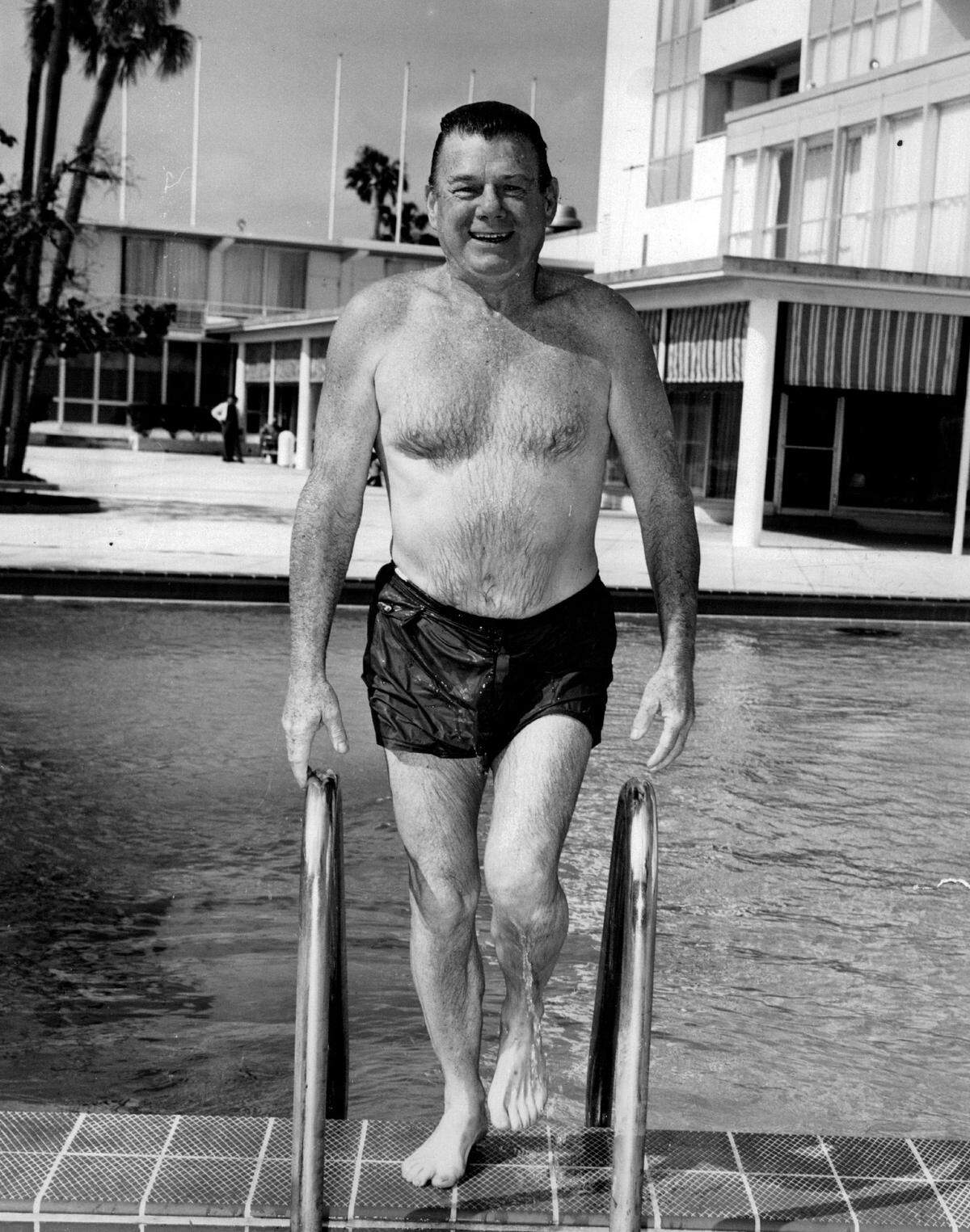 Arthur Godfrey takes a dip in the pool at the Diplomat Hotel in Hollywood, where he broadcast a radio show.