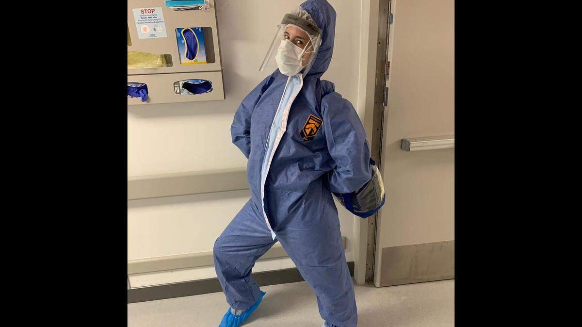 Physical therapist Arielle Brimacombe poses in a hazmat suit while working in the COVID-19 units at Jackson Memorial Hospital, 2020.