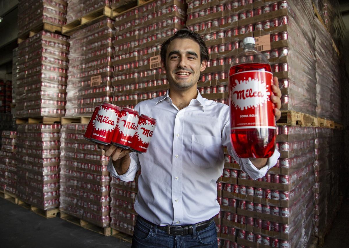 Milca Bottling Co. President and CEO Javier Cuadra shows the canned and bottled Milca soft drink. His family invented the Nicaraguan soft drink Milca Roja 60 years ago.