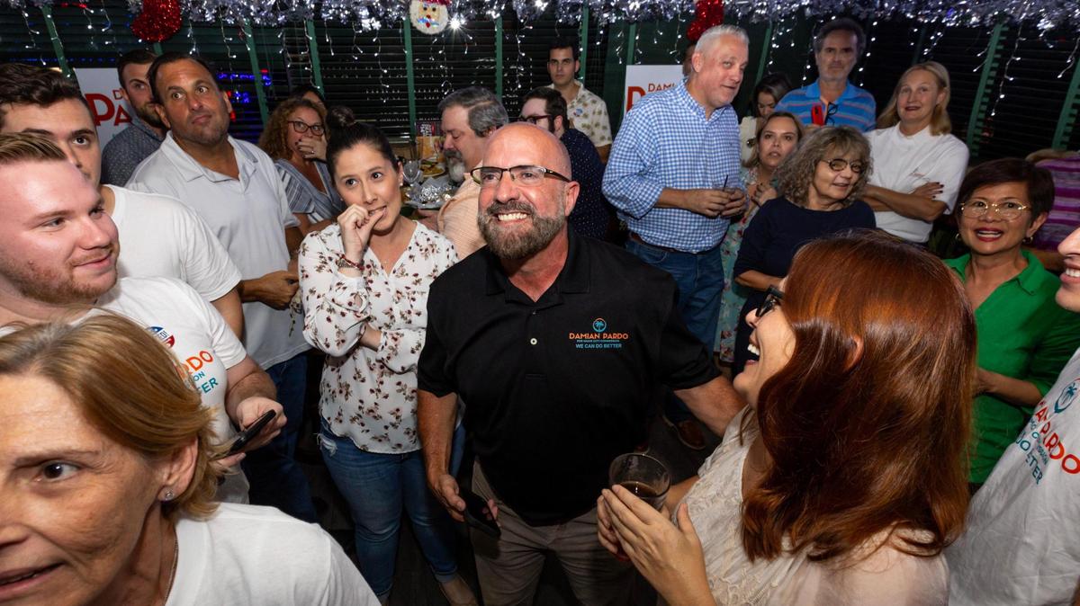 Personal de la campaña, familiares y amigos celebran los resultados que muestran la victoria de Damián Pardo, en el centro, por encima de la comisionada Sabina Covo, durante una fiesta tras la segunda vuelta de las elecciones para el escaño del Distrito 2 de la Comisión de Miami, en Flanigan's, Miami, el  21 de noviembre de 2023.