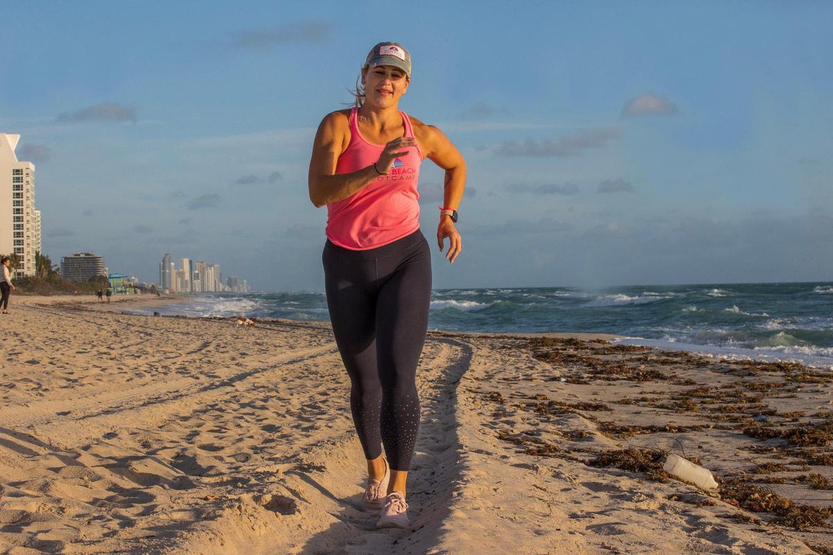 Certified personal trainer Kristen Smith runs during a fitness class she leads on Tuesday, Jan. 28th, 2024 as part of her Miami Beach Fit Camp. She used to weigh 405 pounds and has lost more than 240 pounds since 2006. She will run her first Life Time Miami Marathon on Sunday Jan. 28th.