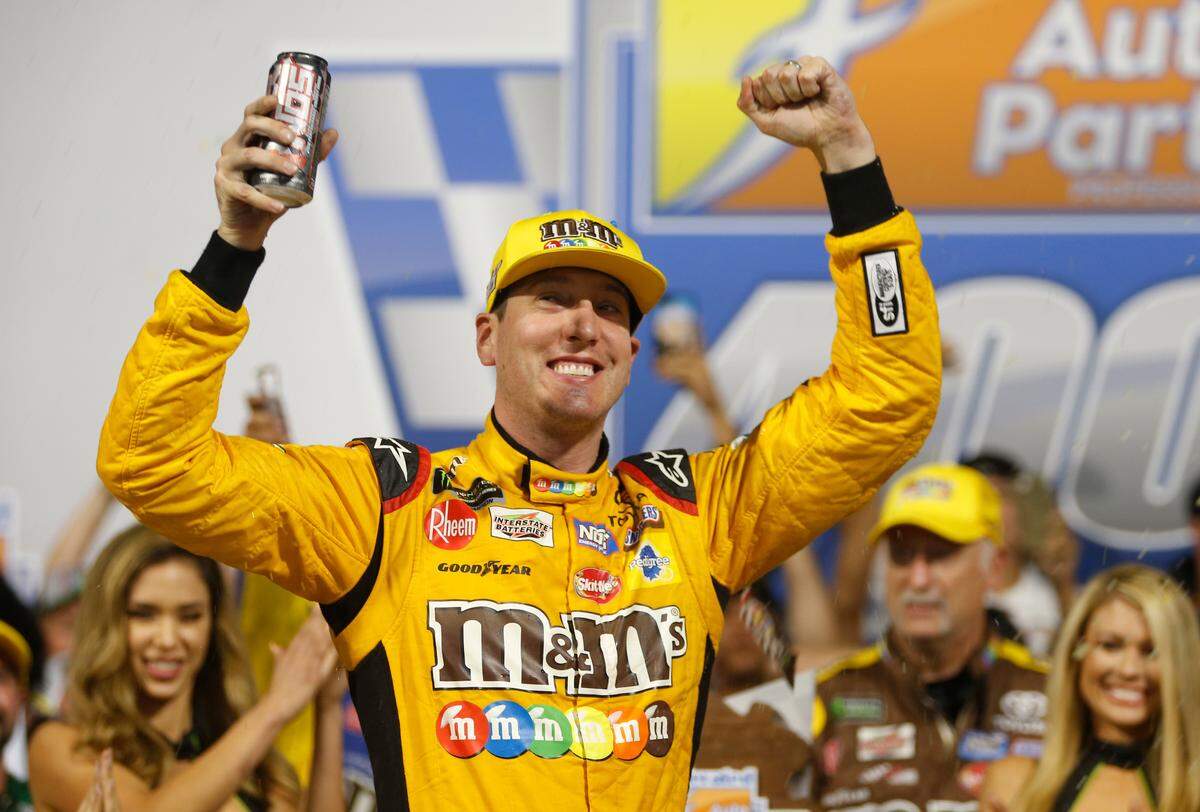 Kyle Busch (18) celebrates winning the NASCAR Monster Energy Series auto race in victory lane at Richmond Raceway in Richmond, Va., Saturday, Sept. 22, 2018. (AP Photo/Steve Helber)