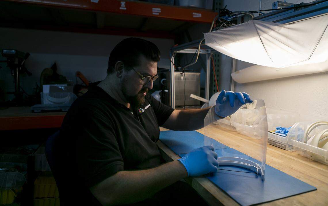 Alexander Hussain, 37, the co-founder of 3D Chimera, puts together a face shield using components he printed at his office in Miami on Wednesday, April 1, 2020. Hussain plans to sell the face shields to local hospitals to help keep workers safe from the coronavirus.