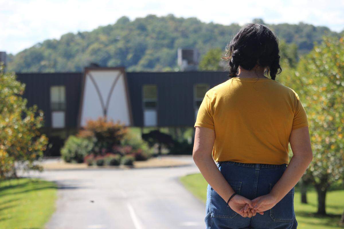 Aurora, a former Peninsula Hospital patient, looks upon the Tennessee psychiatric hospital where she was committed as a teenager. KFF Health News agreed not to publish her full name because she shared private medical history.