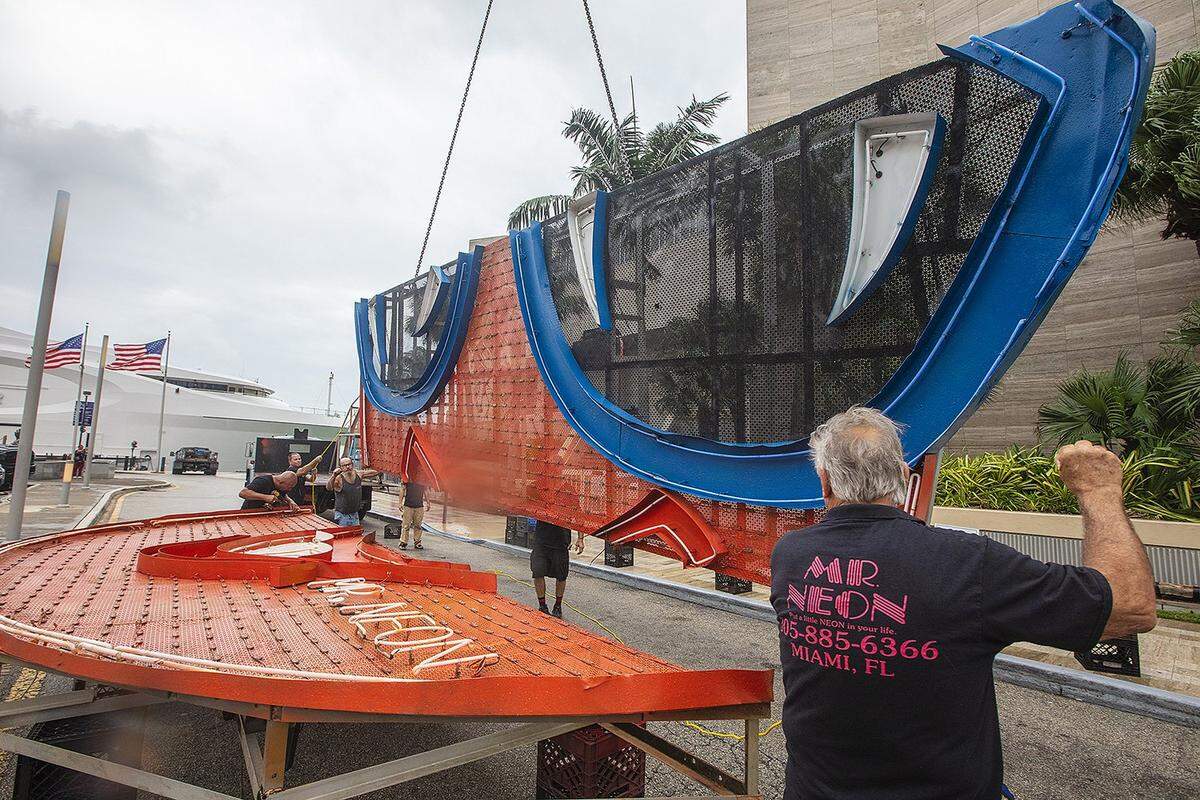 Steve Carpenter, known as “Mr. Neon”, works on the Big Orange installation, a centerpiece of Miami’s NYE tradition, on Friday, December 27, 2024, at the InterContinental Hotel in Downtown Miami.