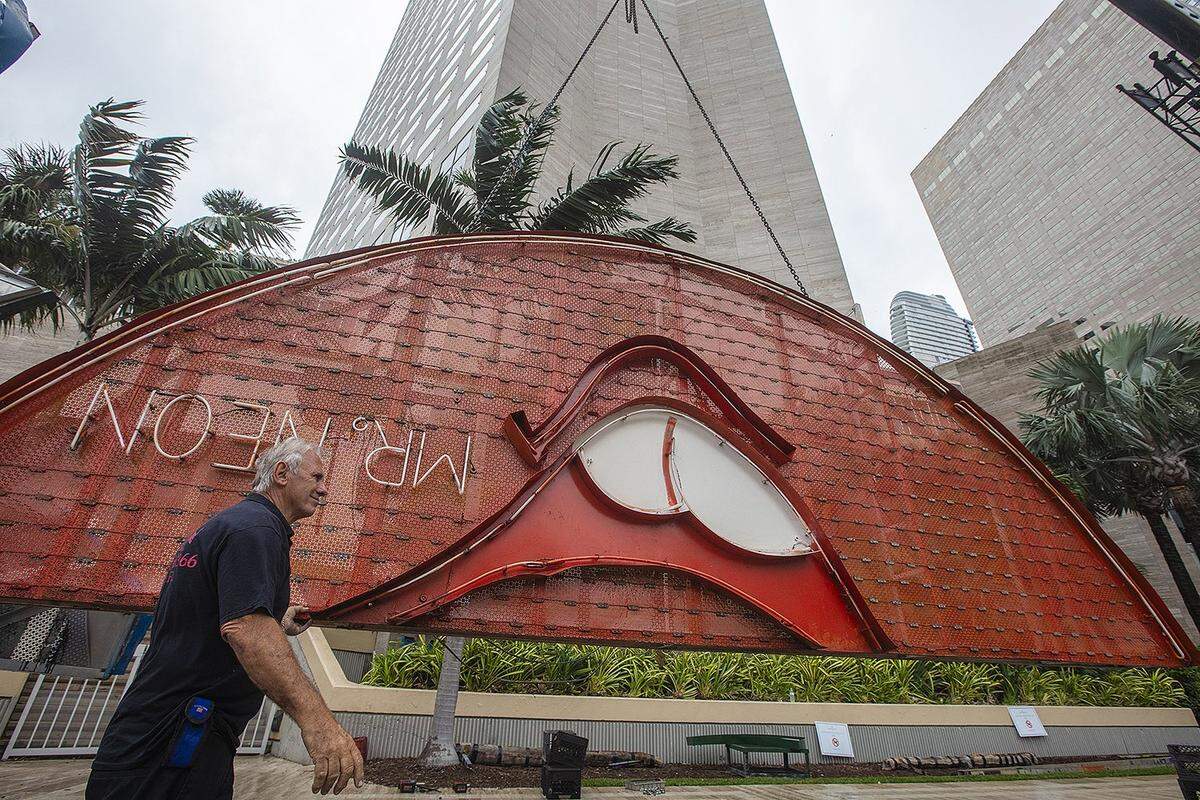 Steve Carpenter, known as “Mr. Neon”, works on the Big Orange installation, a centerpiece of Miami’s NYE tradition, on Friday, December 27, 2024, at the InterContinental Hotel in Downtown Miami.