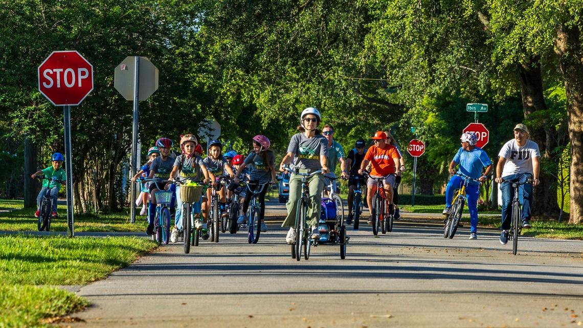 Noel Gonzalez leads a group of students and parents as part of the Springview Bike Bus group riding to school, led by parent volunteers, every Friday morning. They ride to Springview Elementary School in Miami Springs, on Friday, May 24, 2024.