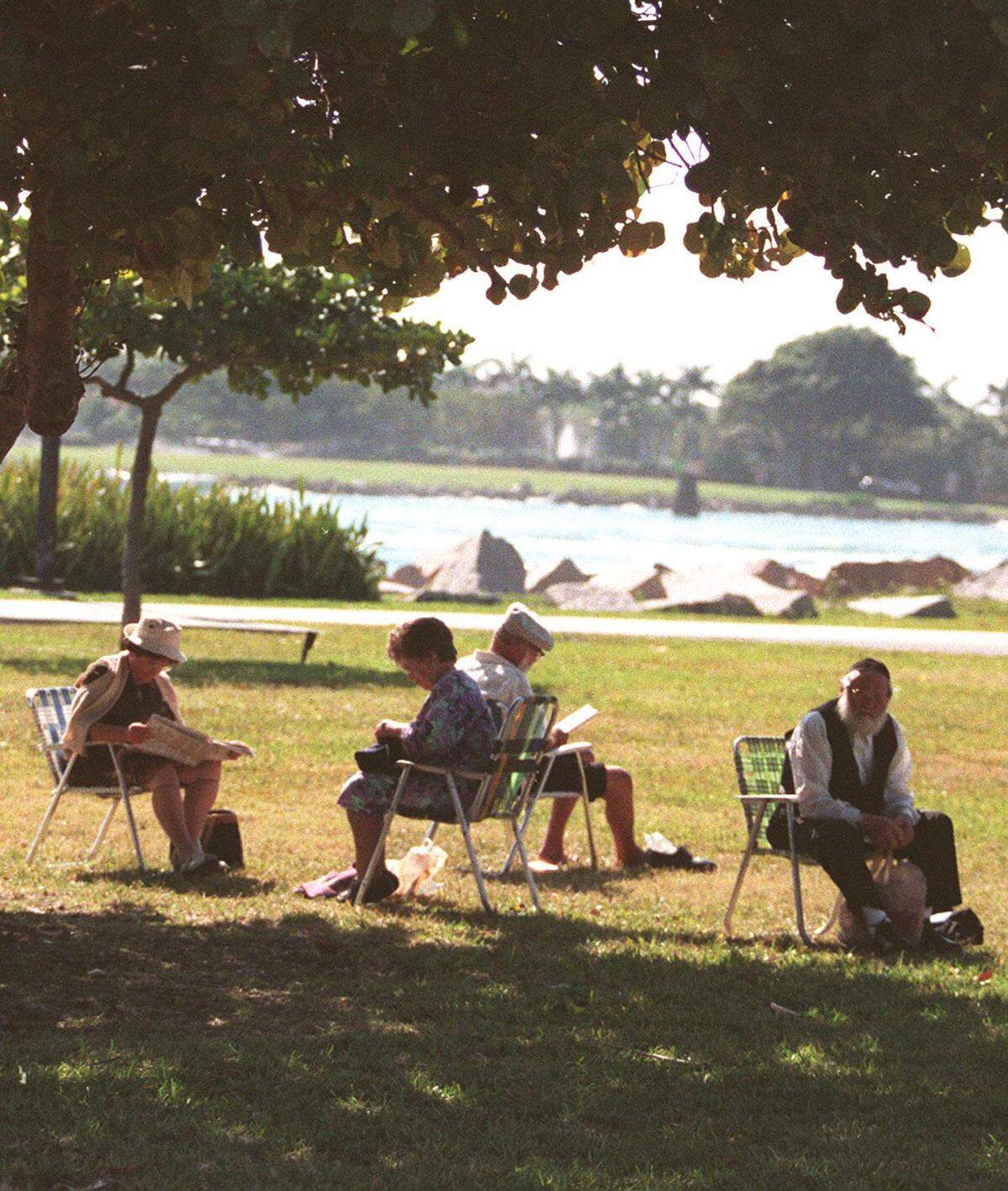 A group of retired people relax at South Pointe Park in Miami Beach.