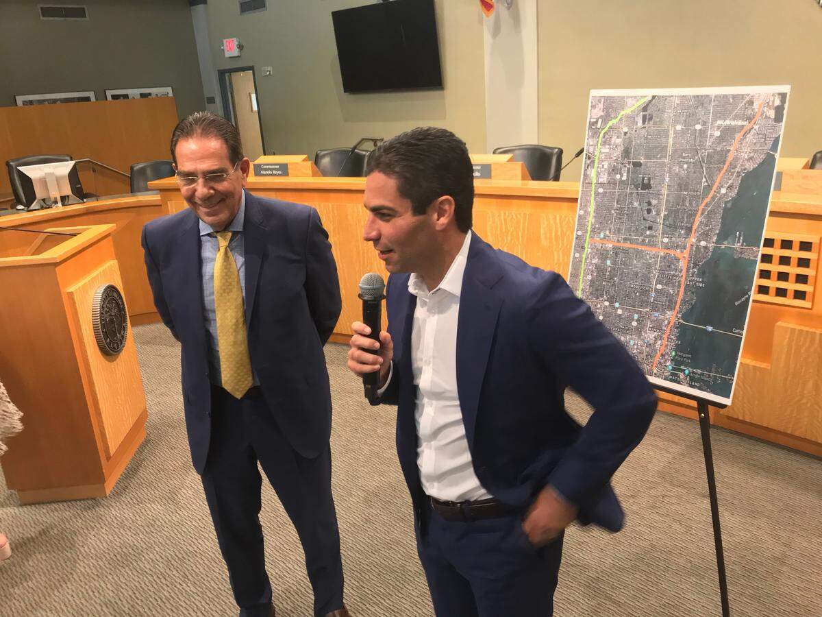 Miami-Dade Commissioner Xavier Suarez, left, and his son, Miami Mayor Francis Suarez, discuss potential stops for Tri-Rail in the city, where the elder Suarez also once served as mayor. Now he’s running for county mayor in 2020. The discussion was part of a Tri-Rail meeting held at Miami City Hall on Friday, Nov. 1, 2019.