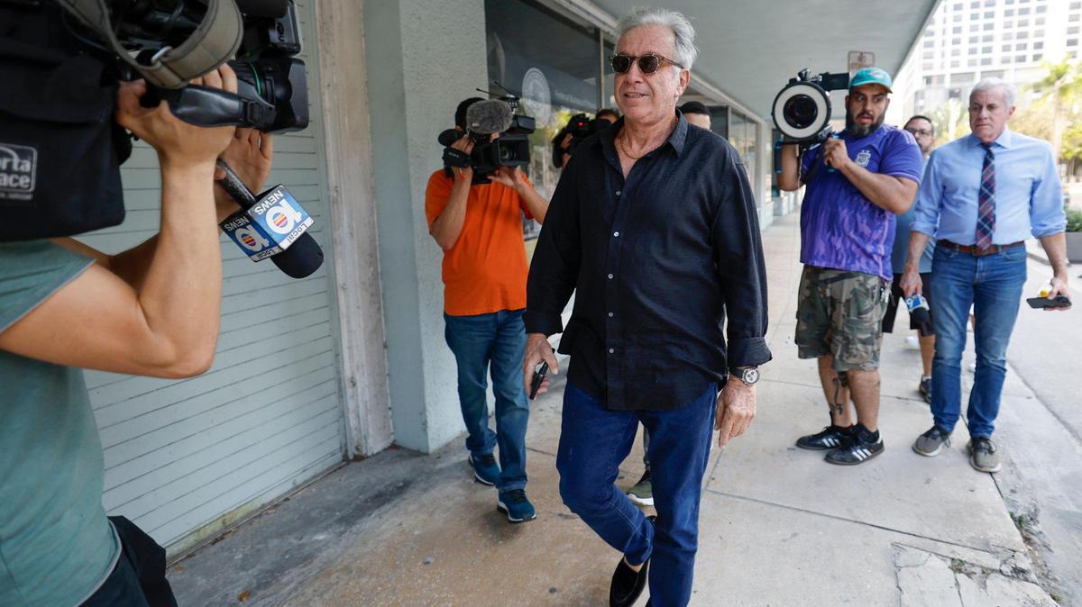 Shlomi Alexander, trailed by media members, leaves Miami federal court on Friday. Three of his sons are charged with conspiring to commit sex-trafficking involving dozens of women in New York and South Florida between 2010 and 2021.