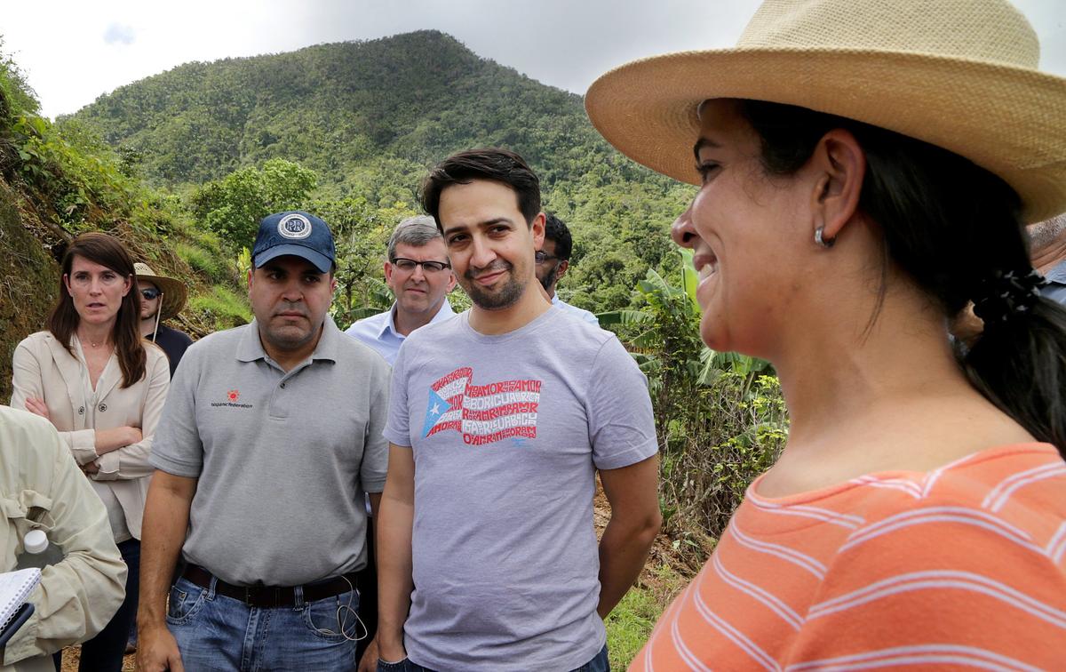 Coffee farmer Vanessa Arroyo with Lin-Manuel Miranda, center, and Jose Calderon, left, president of the Hispanic Federation, during  a walking tour of Puerto Rico coffee farms, part of an effort by Nespresso, the Rockefeller Foundation, Starbucks, the Hispanic Federation and TechnoServe to support the island’s coffee industry after Hurricane Maria.