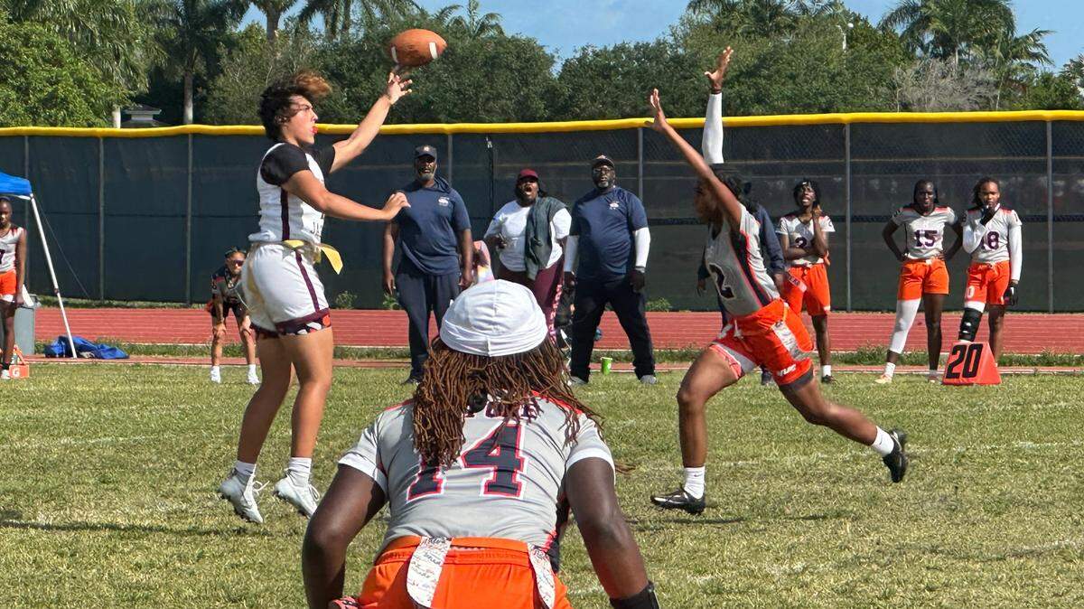 Pembroke Pines Charter quarterback Ava Rivera throws a pass over a rushing Homestead defender during the Jaguars’ 26-6 win over the Broncos on Friday afternoon at Homestead High.