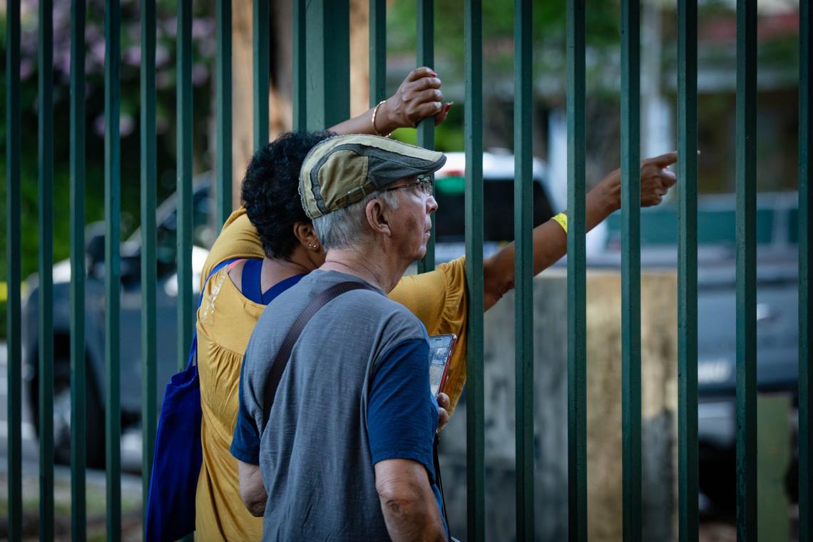 Former residents of Temple Court Apartments view the demolition of the building from Lummus Park on 404 NW Third St. on Tuesday, June 18, 2024 in Miami, Fla. The city of Miami began to demolish the complex Tuesday after a fire swept through it last week.