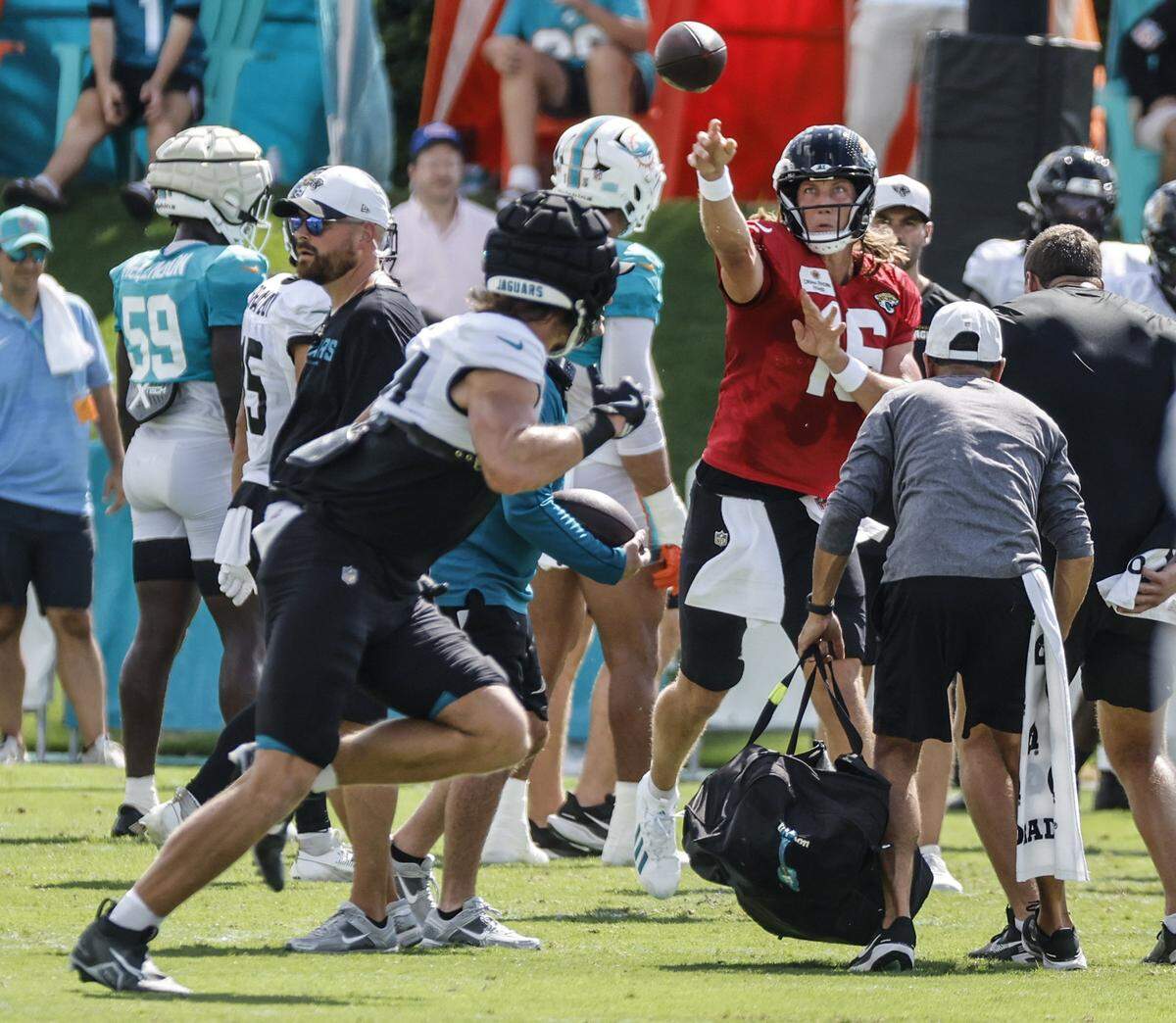 Jacksonville Jaguars quarterback Trevor Lawrence (16) throws a pass during an NFL football joint practice with the Miami Dolphins.