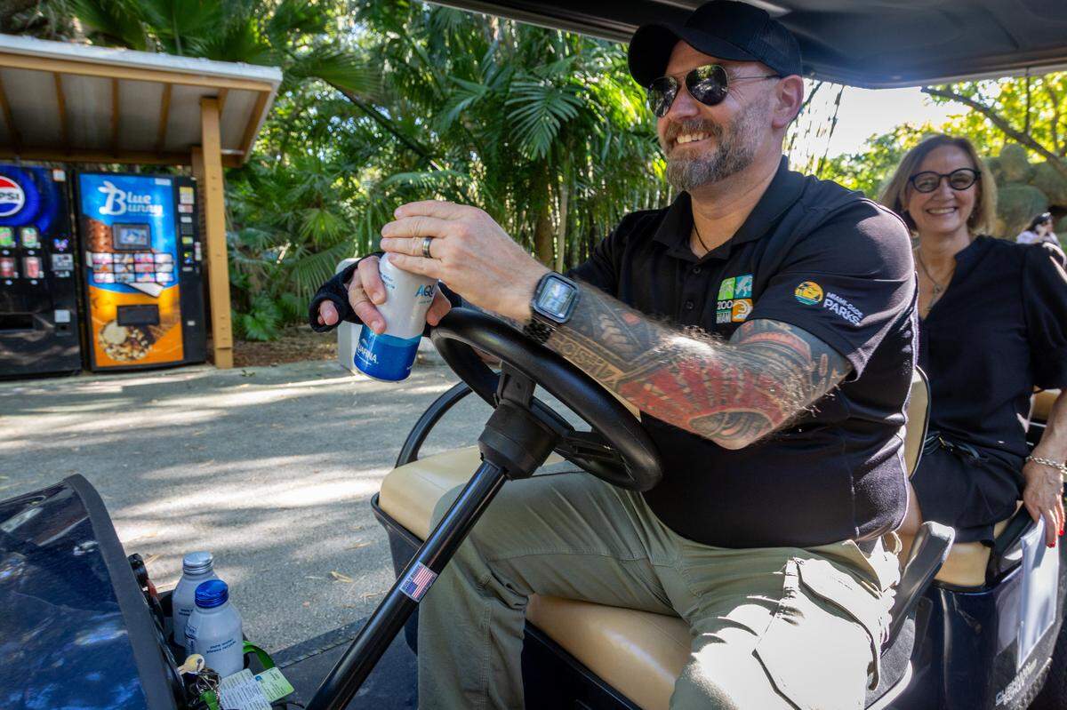 Aluminum water bottle in hand, William Elgar, the director of Zoo Miami, guides Miami-Dade County Commissioner Eileen Higgins on a tour of the zoo, which is a model for reducing plastic waste.