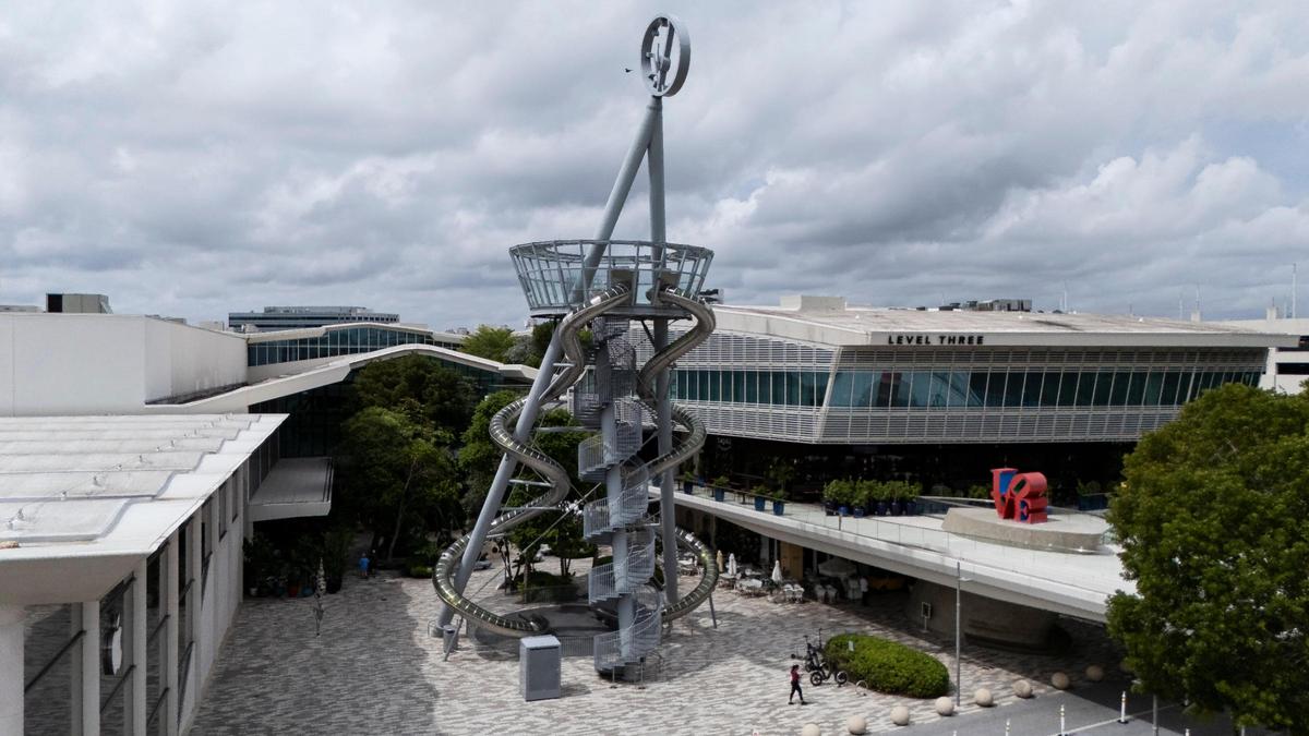 An aerial view of Carsten Höller’s 93-foot glass-and-steel slide and Robert Indiana’s ‘Love’ sculpture are among the art installations welcoming visitors to Aventura Mall on Sept. 25, 2024, in Aventura, Fla.