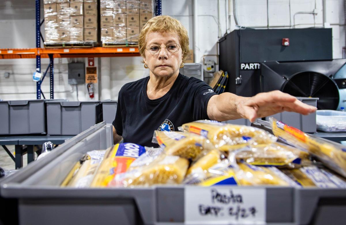 Volunteer at Global Empowerment Management HQ, Victoria Greber, places uncooked pasta into a care package that would be sent to areas in the Caribbean affected by Hurricane Beryl at 1850 NW and 84th Ave. on Tuesday, July 2, 2024 in Doral, Fla.