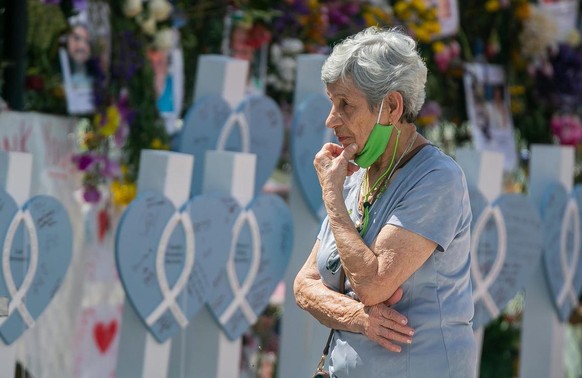 A woman visits the Surfside Wall of Hope & Memorial as recovery efforts continue at the collapsed Champlain Towers South condo building in Surfside on Friday, July 9, 2021.
