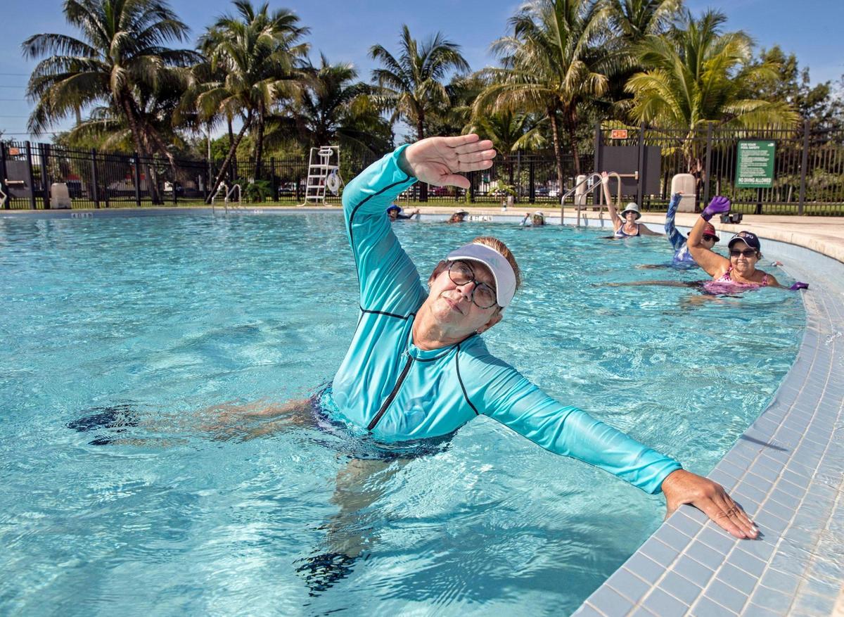 Caridad Blanco, 67, exercises during the water aerobics class at Miami-Dade County’s North Pointe Community Center on Friday, October 16, 2020. The participants take part in the Silver Sneakers program, a perk in a number of Medicare Advantage plans.