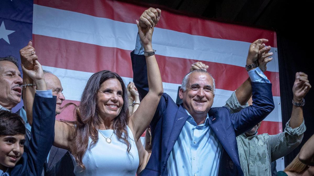 Steve Bovo, right, with his wife, Viviana, raises his arms to applause after he won the Hialeah mayor’s race on Nov. 2.