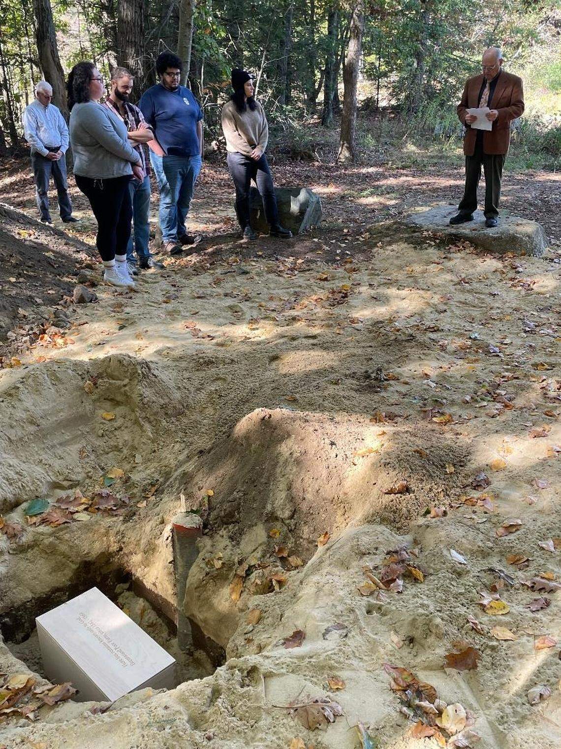Faculty and students during a eulogy given by Albert Edward Belanger, a Brentwood cemetery trustee, at the reburial ceremony.