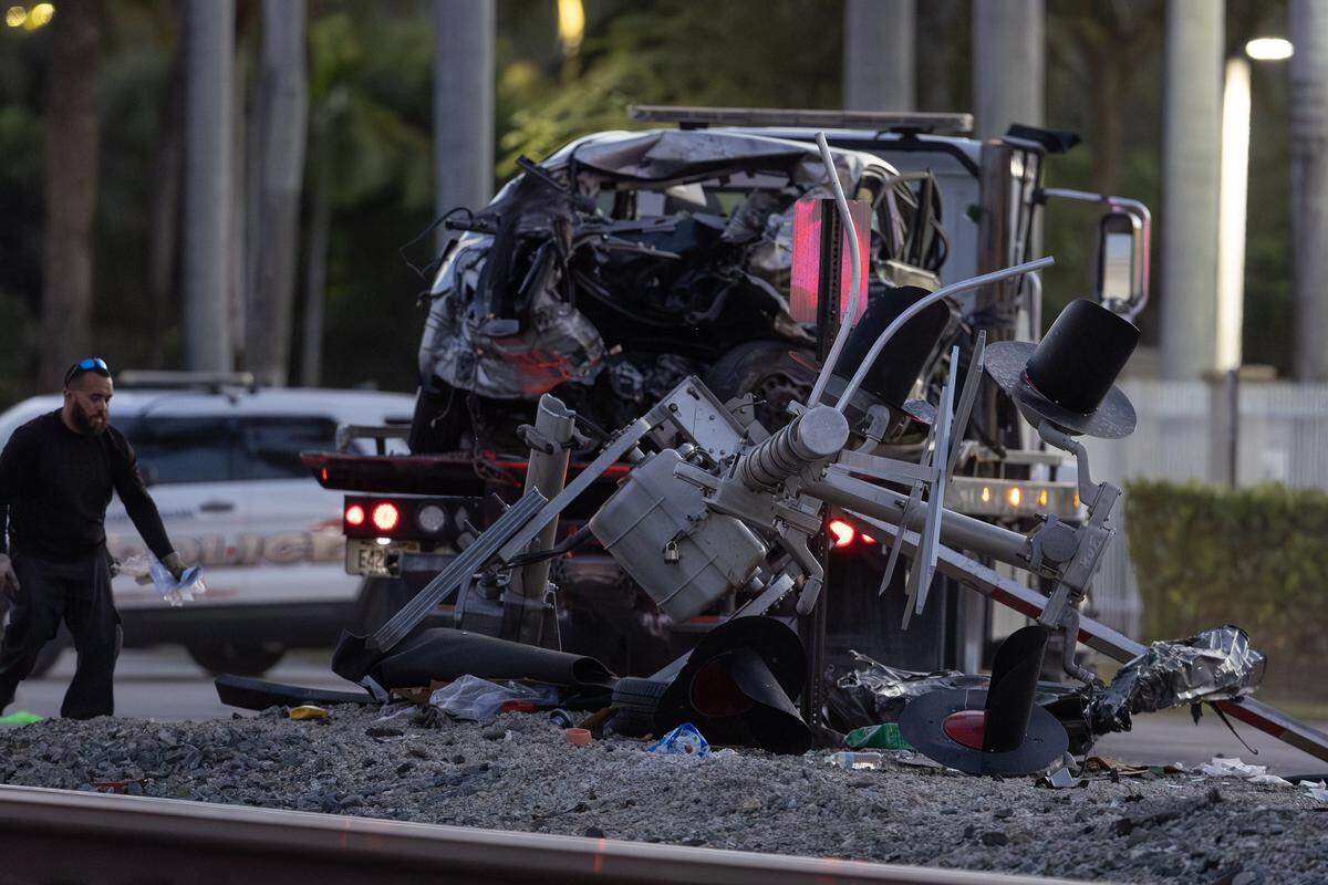A vehicle involved in a collision with a Brightline train is seen as officials clear the area before it is removed from the crash scene near the 14100 block of Biscayne Boulevard in Miami on Wednesday, Nov. 19, 2025. One person was airlifted to a trauma center.