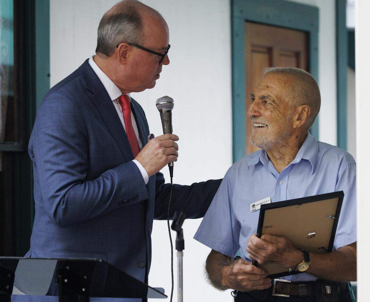 Broward County Commissioner Lamar Fisher, left, honors John Della-Cerra Jr., groundskeeper and caretaker of the Historic Stranahan House Museum for 35 years, during a groundbreaking ceremony to celebrate the new amenities being built on the property.
