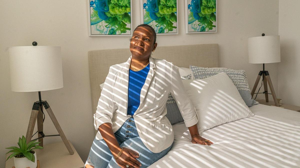 Tenant Indira Cala Rodriguez, 37, relaxes in her new townhome in Lincoln Gardens in Miami, on Dec. 20, 2022.