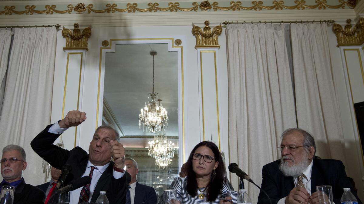 Members of the Cuban delegation from left, senior researcher Mitchell Joseph Valdes Sosa, Deputy Director for North America at the Cuban Ministry of Foreign Affairs Johana Tablada and Pedro Antonio Valdes Sosa speak during a news conference about the mystery attacks on diplomats in Cuba this week.
