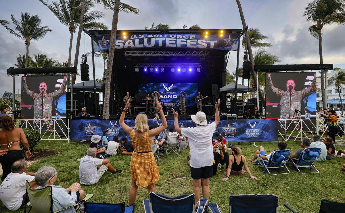 the U.S. Air Force Band performs on stage as attendees celebrate during Memorial Day Weekend at the Hyundai Air & Sea Show in Miami Beach, Florida, on Saturday, May 23, 2026.