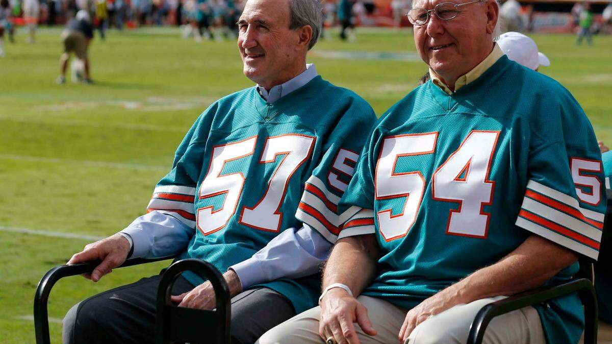 Former Miami Dolphins team of 1972, Mike Kolen (57) and Howard Kindig (54) are driven on the field for a half time celebration at an NFL football game against the Jacksonville Jaguars, Sunday, Dec. 16, 2012, in Miami. (AP Photo/John Bazemore)