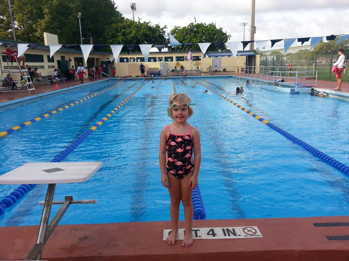 Miami resident David Winker’s 5-year-old daughter, Cristina, at Shenandoah Pool. Winker lined up at 12:40 a.m. to register his daughter for a month of swim lessons.