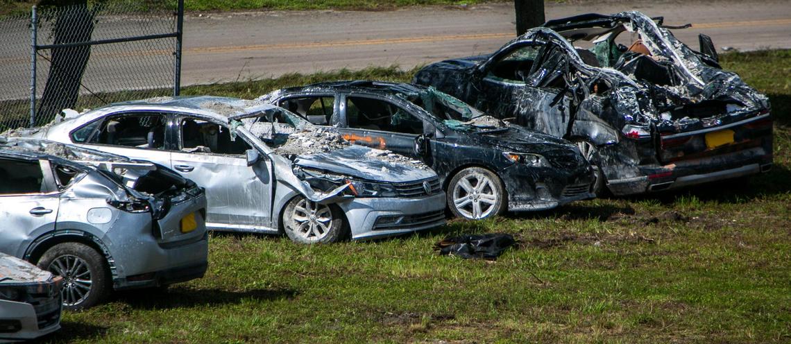 Burned and damaged cars believed to be from the Champlain Towers South collapse site on Friday, July 2, 2021. Debris from what is believed to be the site of the Champlain Towers collapse in Surfside is being dumped next to the ramp of 826 East on the Golden Glades interchange.