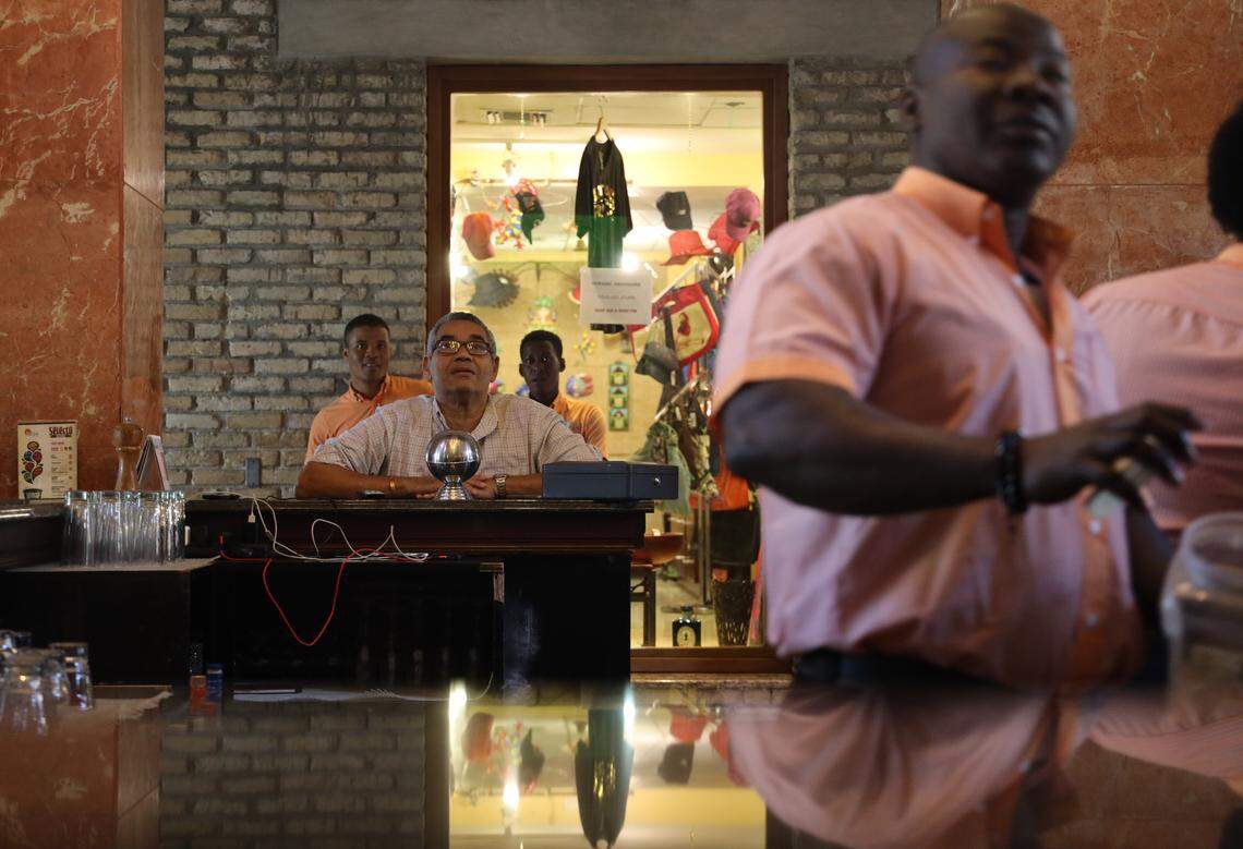 A hotel guest watches a soccer match surrounded by the staff at the lobby bar of the Karibe Hotel. On Tuesday, Feb. 19, 2019, staff outnumbered guests as most of the hotel’s rooms were empty after a heavy drop in occupancy rates followed travel advisories issued by United States.