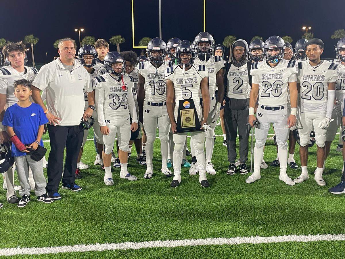 NSU University School players and coaches receive their Sunshine State Athletic Conference state runner-up trophy after falling 49-42 against Oviedo Master’s Academy on Saturday night at The Villages High School in The Villages, Fla.